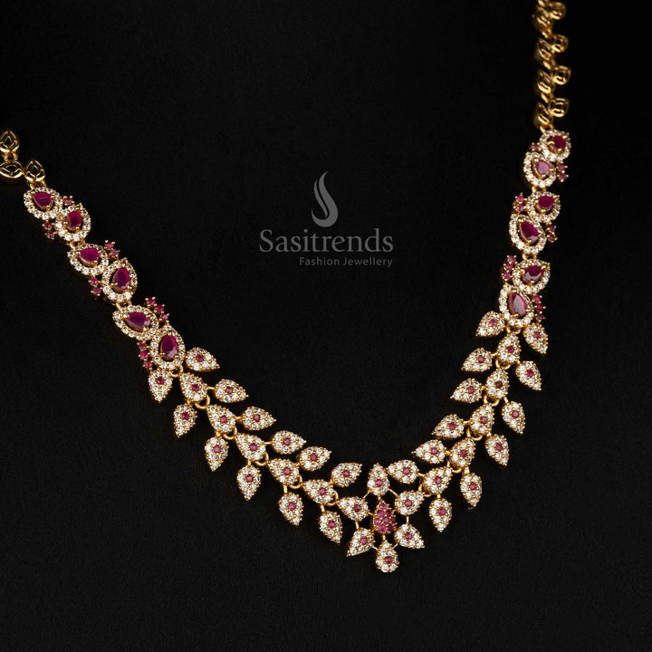  Elegant matte gold plated temple jewellery set with sparkling white and ruby AD stones, detailed leaf motif, floral tilak design - Sasitrends