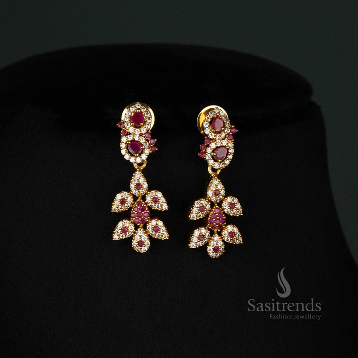 Royal temple-style matte gold plated jewellery set with intricate leaf motifs, floral tilak design, white and ruby embellishments, and finely crafted earrings - Sasitrends