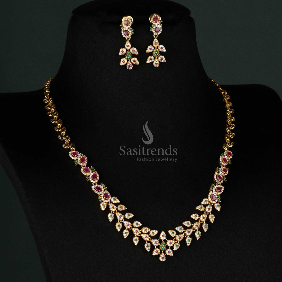 South Indian designer temple jewellery set in matte gold plating, adorned with colorful AD stones, intricate leaf motifs, and a floral tilak design, including matching earrings - Sasitrends