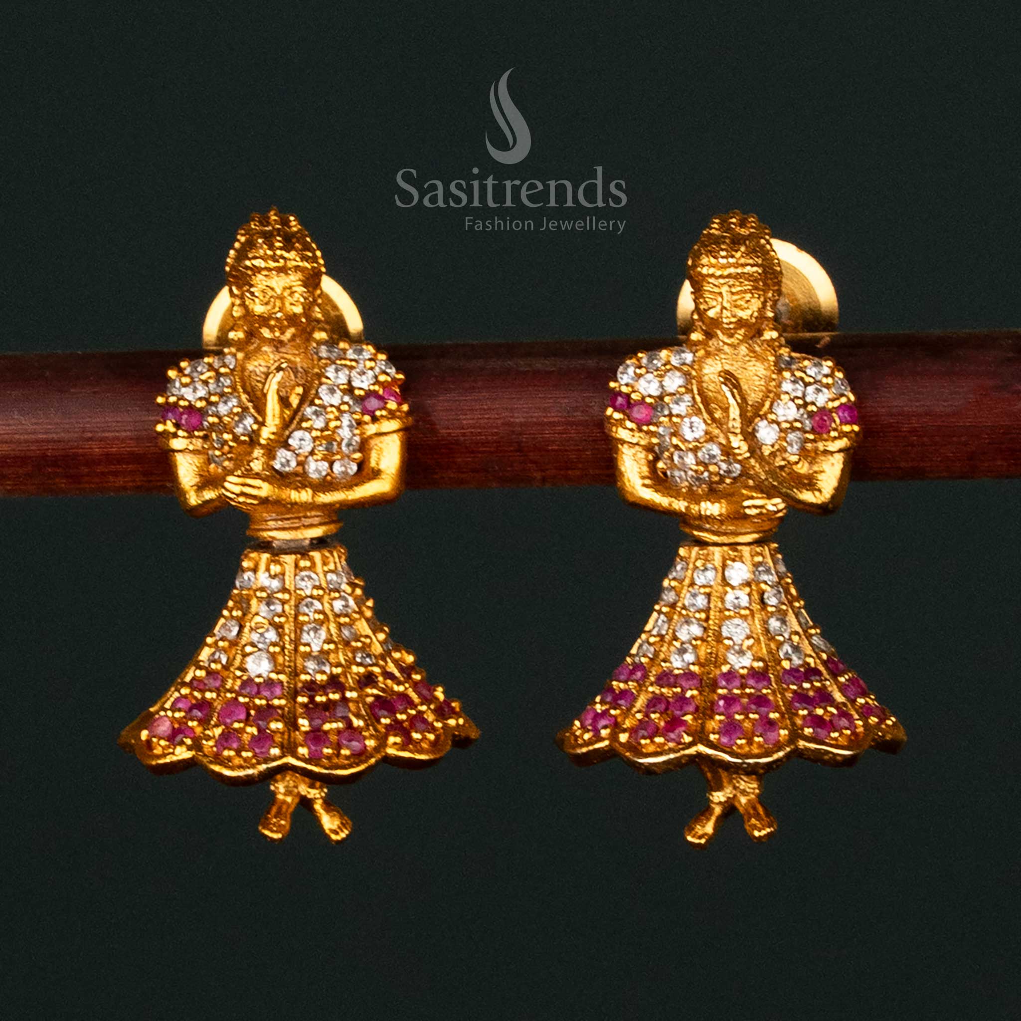 Radiant white-ruby temple matte gold plated Butta Bomma earrings designed with divine motifs, a statement piece for bridal elegance and ethnic charm - Sasitrends