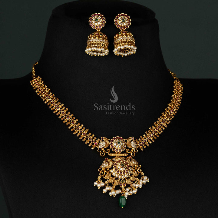 Vibrant temple matte gold-plated necklace set with ruby-green peacock and floral pendant, pearls, and matching jhumkas - Sasitrends