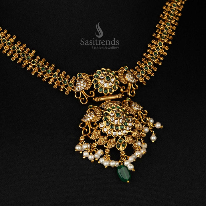 Intricate matte gold temple necklace set in green with pearls, peacock designs, and a beaded chain - Sasitrends