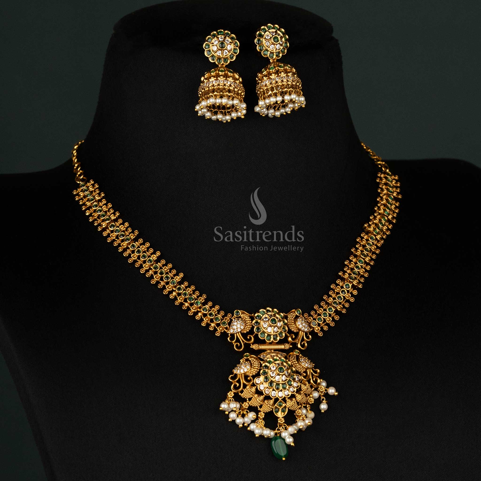 Opulent gold-plated necklace with green embellishments, a stunning floral pendant, and coordinated jhumkas - Sasitrends