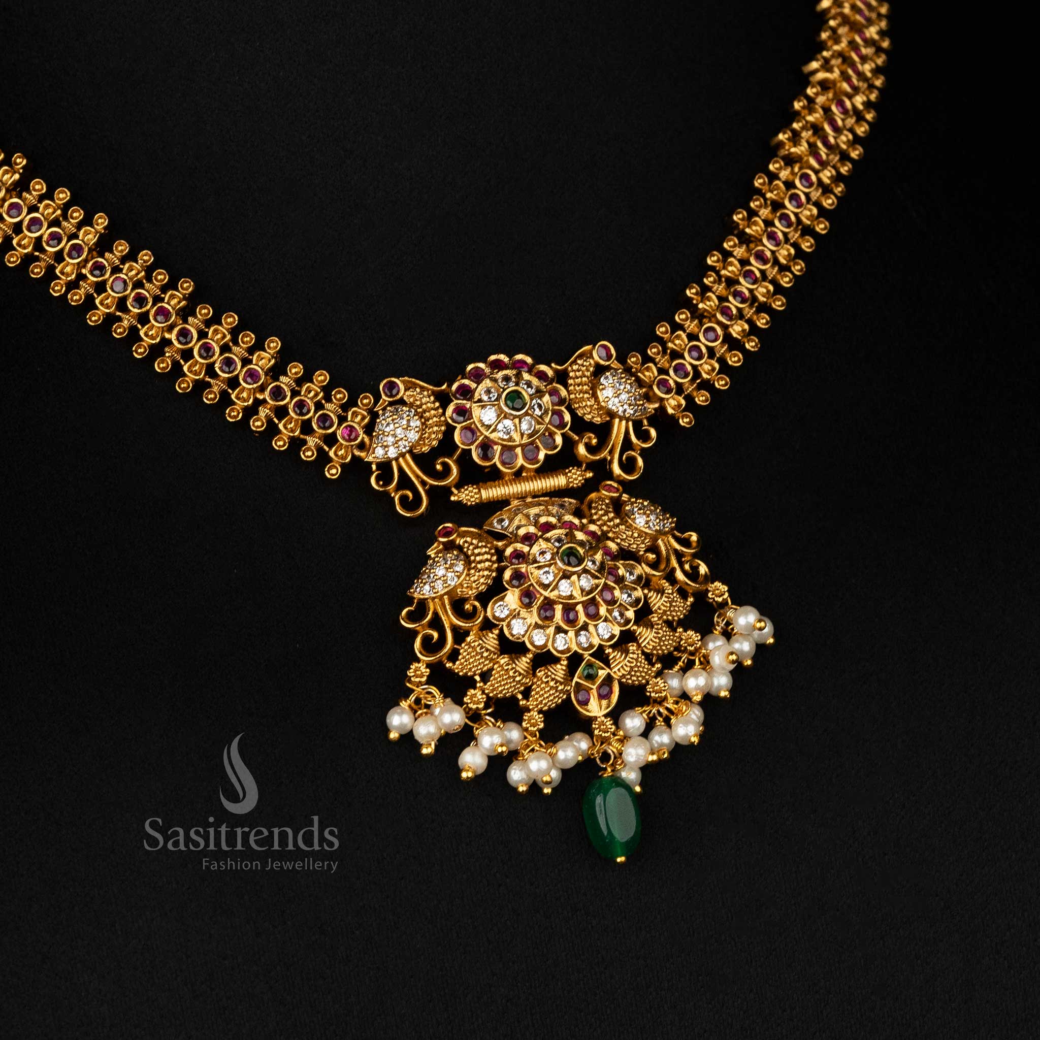 Timeless matte gold-plated temple jewelry set with ruby-green dual-tone details and intricate motifs - Sasitrends