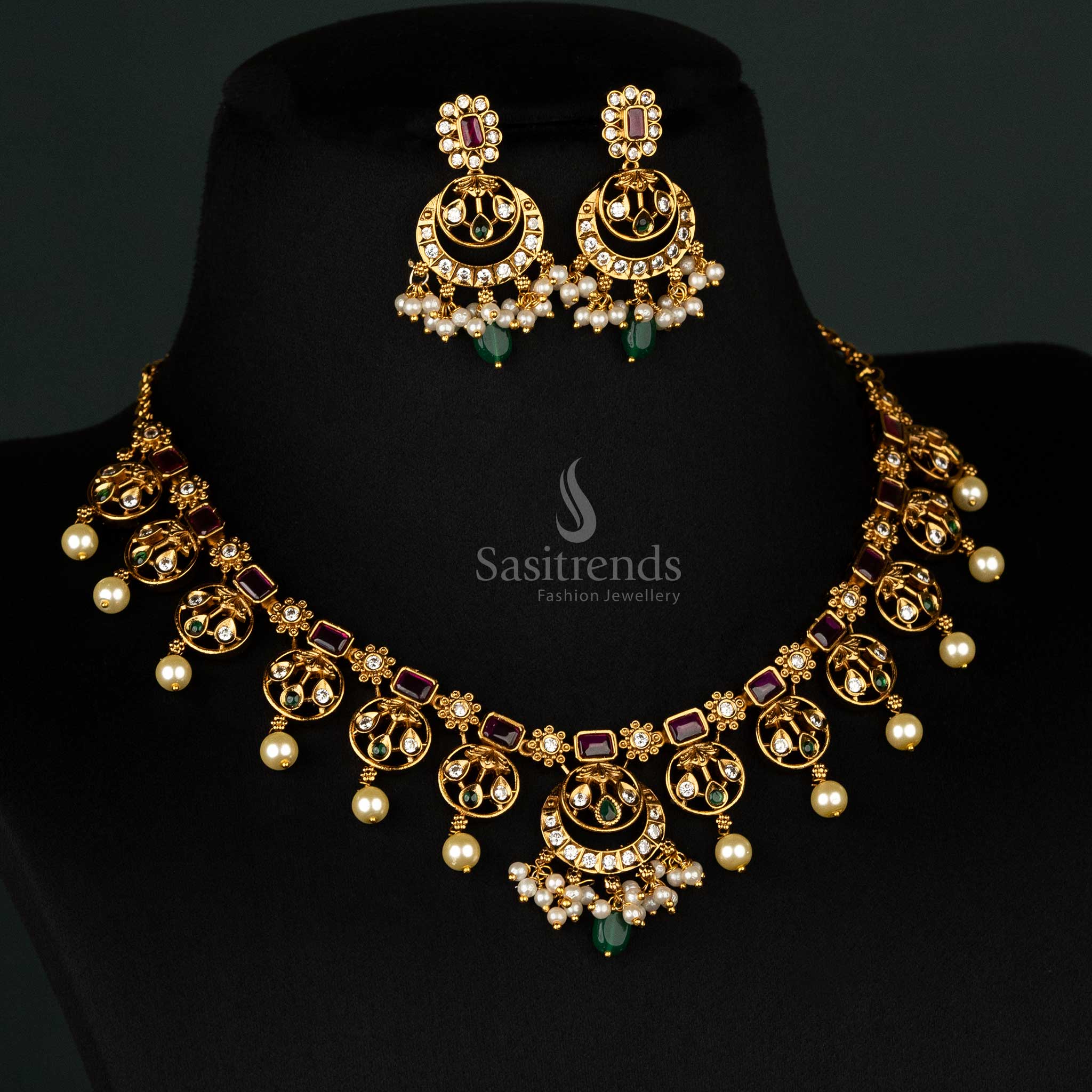 Grand dual-tone matte gold-plated necklace set in ruby-green with floral pendant, pearls, and coordinated jhumkas - Sasitrends