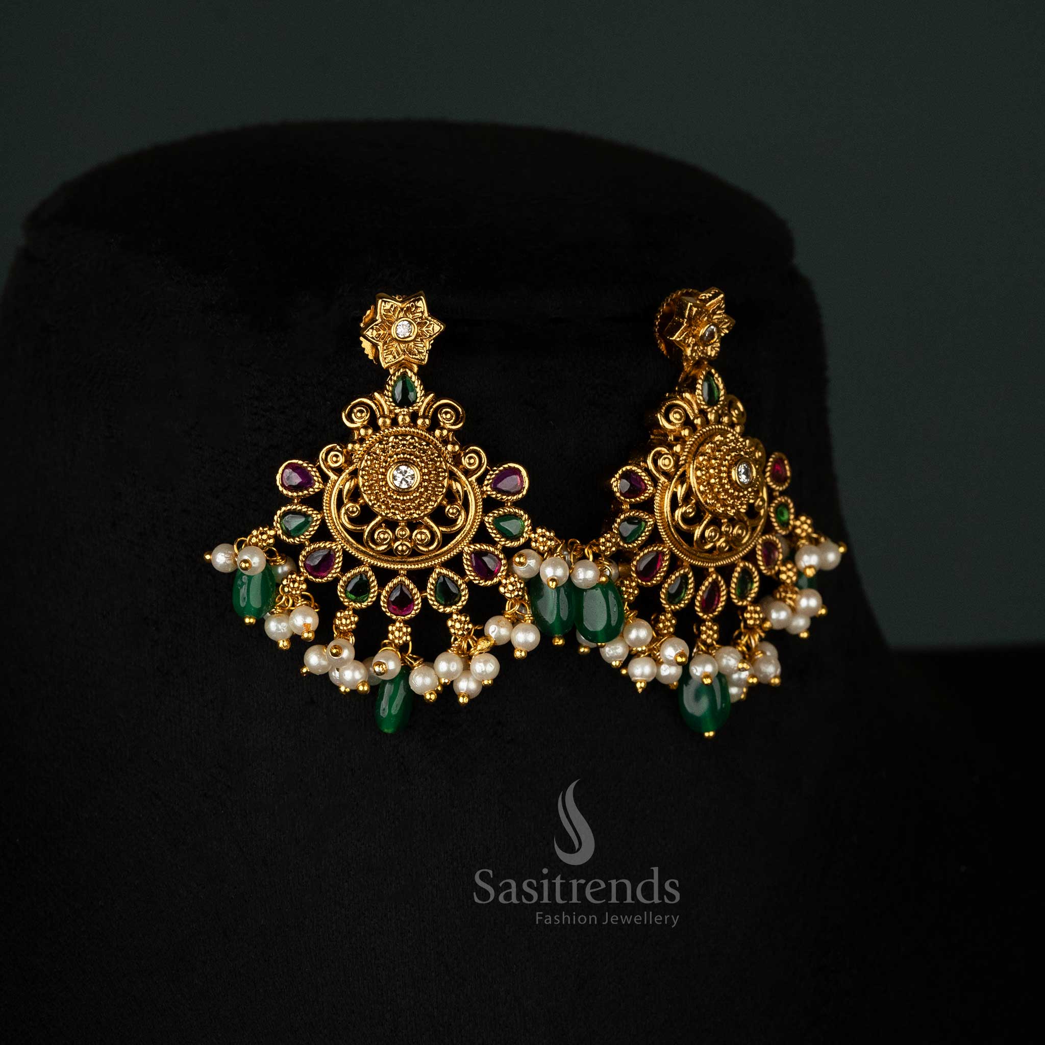 Luxurious traditional earrings set with matte gold plating, ruby and green beads, intricate filigree design, and pearl embellishments - Sasitrends