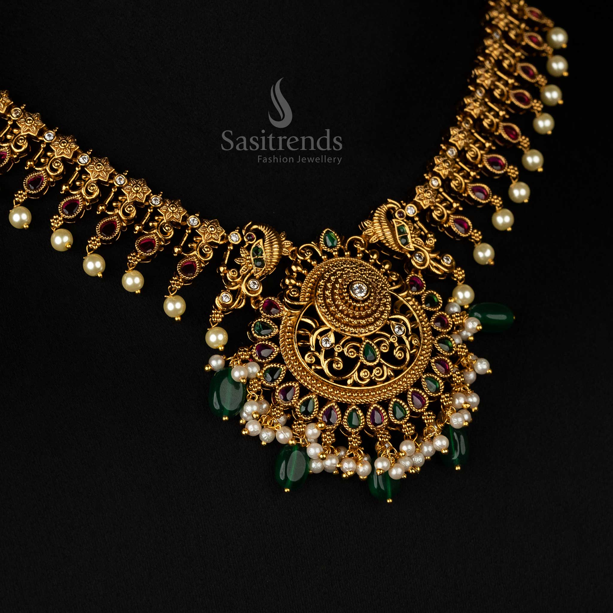 Premium matte gold jewellery featuring ruby and green beads, delicate filigree craftsmanship, and elegant pearl details  - Sasitrends