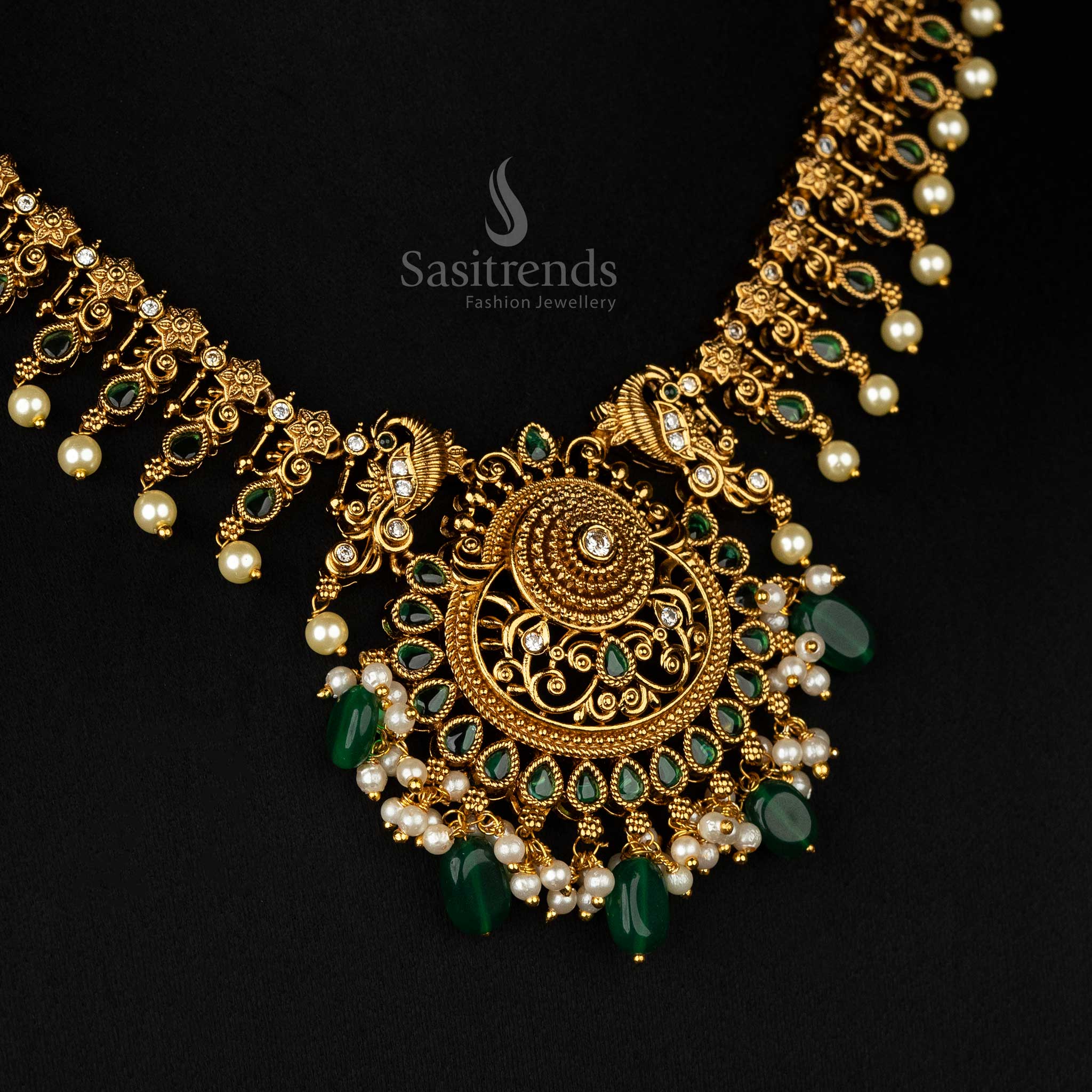 Graceful traditional jewellery set with matte gold plating, green beads, intricate filigree design, and pearl accents - Sasitrends