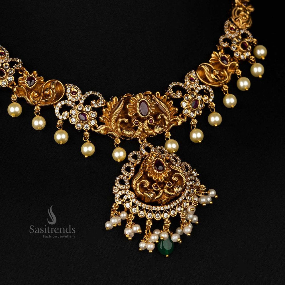 Magnificent matte gold temple jewellery necklace set with an intricate peacock design, ruby stones, cascading pearls, and a regal finish - Sasirends