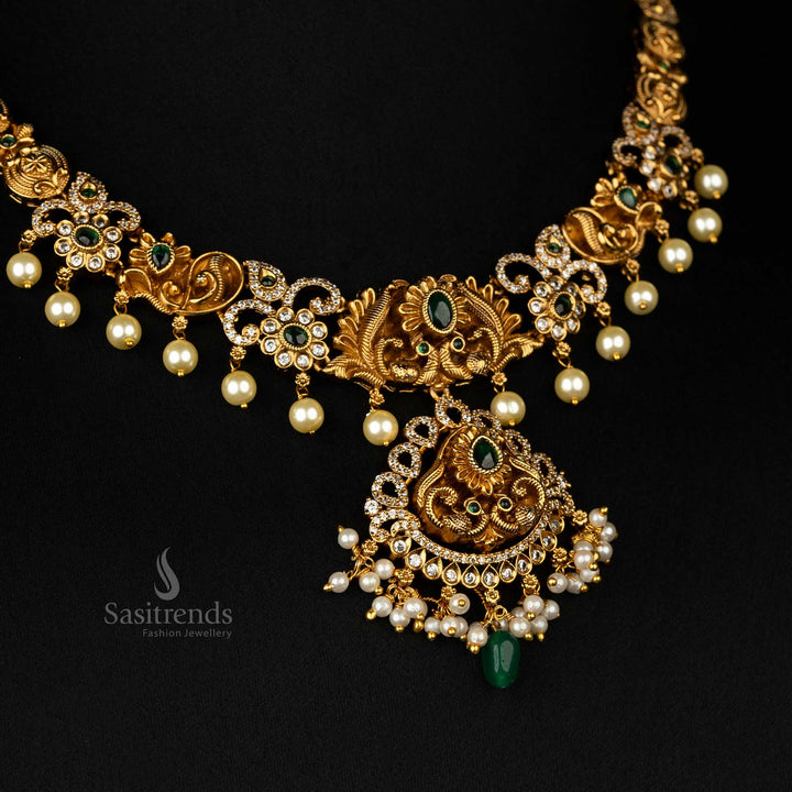 Regal temple necklace featuring green stones, matte gold plating, and an intricately designed peacock with pearl embellishments - Sasitrends