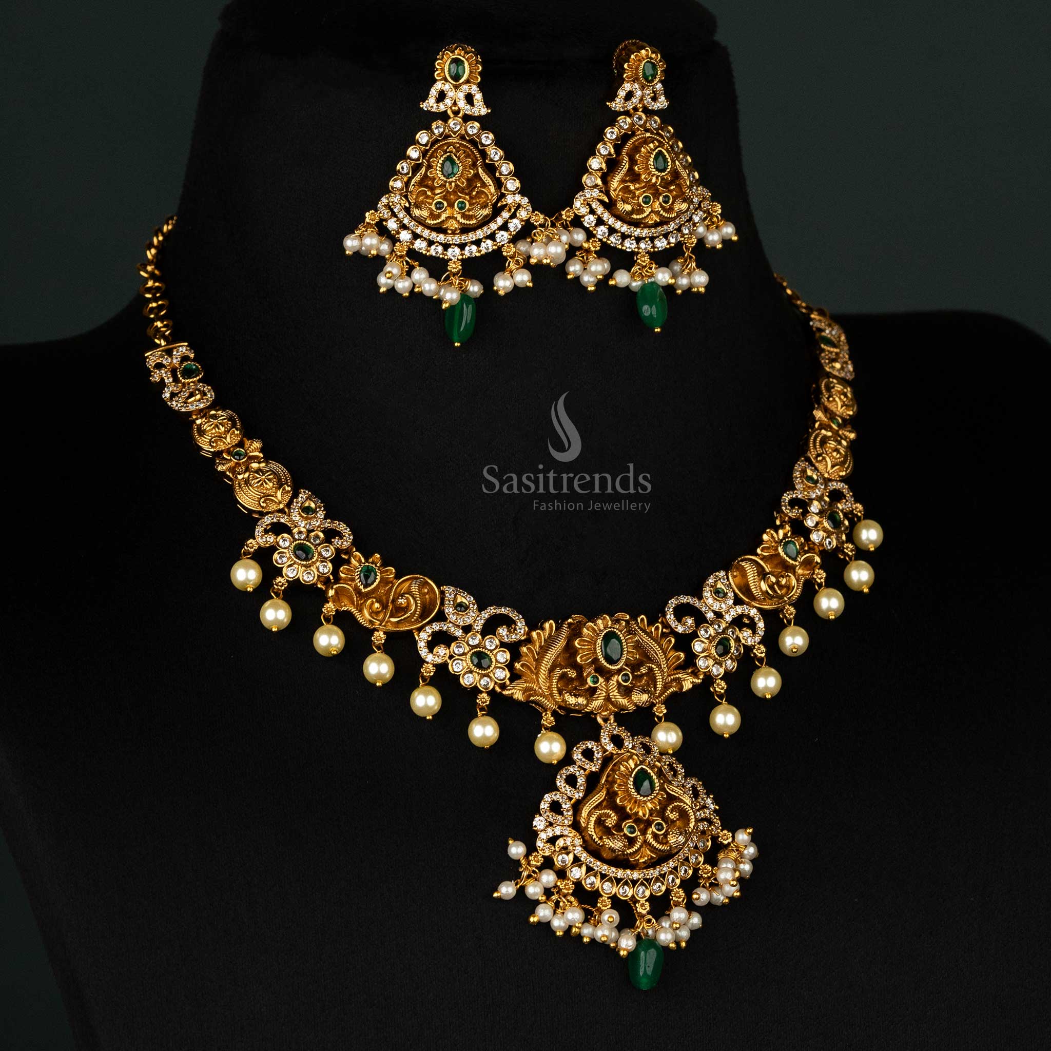 Graceful matte gold necklace with green stones, a central peacock design, and delicate cascading pearls - Sasitrends