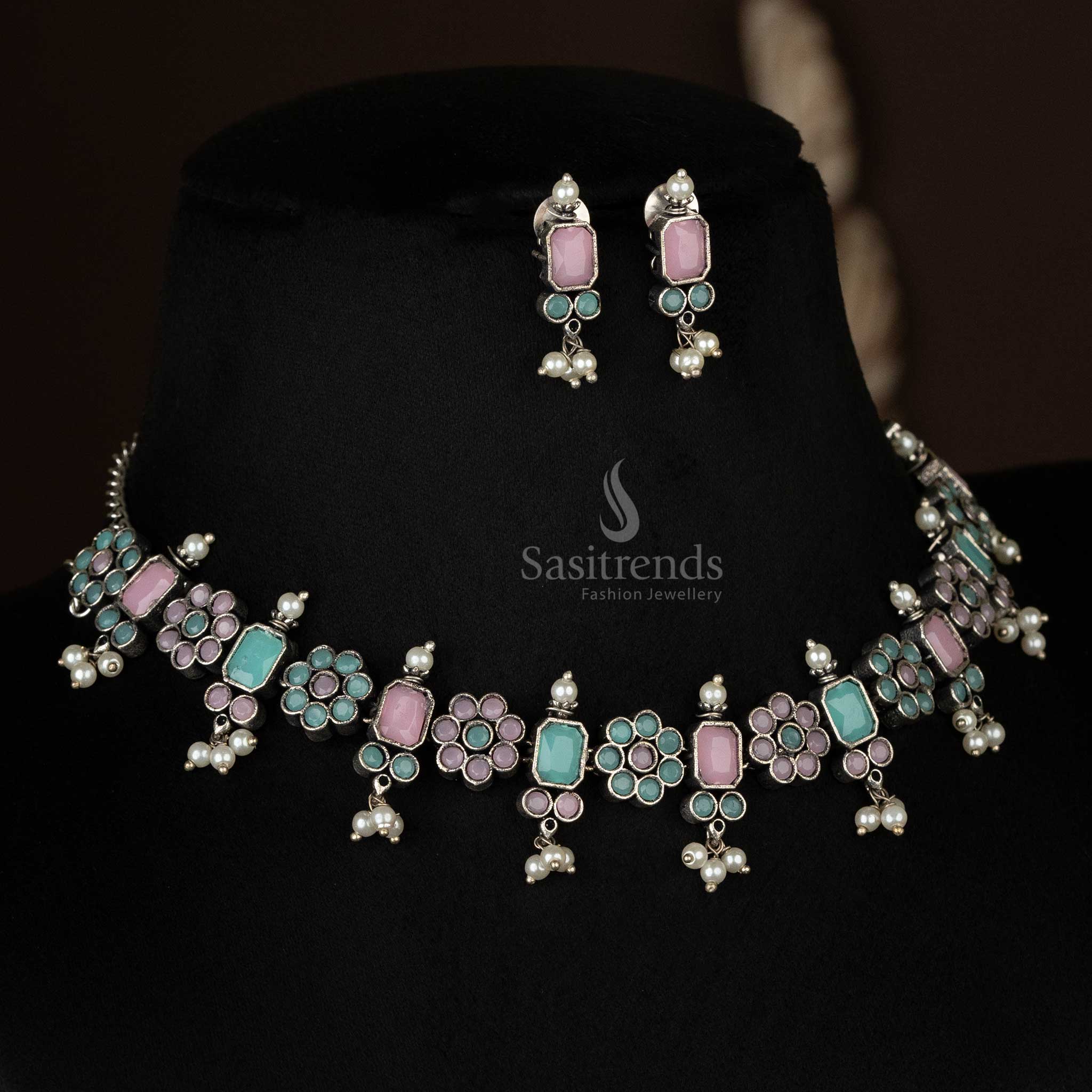 Exquisite oxidized floral necklace set with pearl drops in pink and mint, offering a unique blend of colors for an artistic statement - Sasitrends