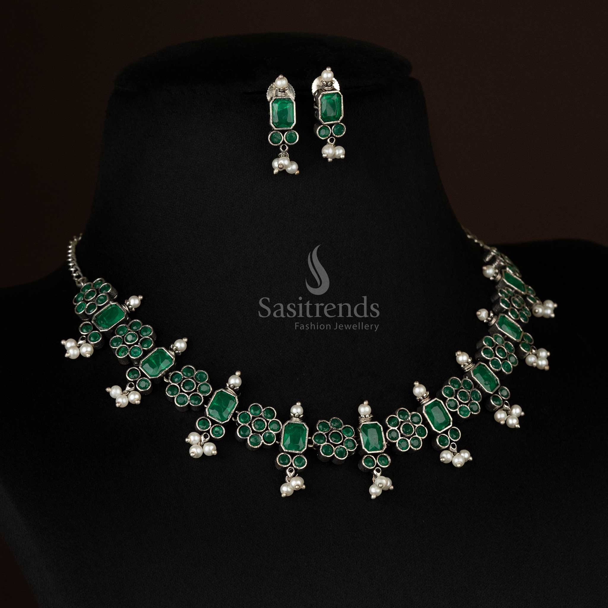 Radiant oxidized floral necklace set with pearl drops in emerald green, enhancing the elegance of ethnic and contemporary outfits - Sasitrends