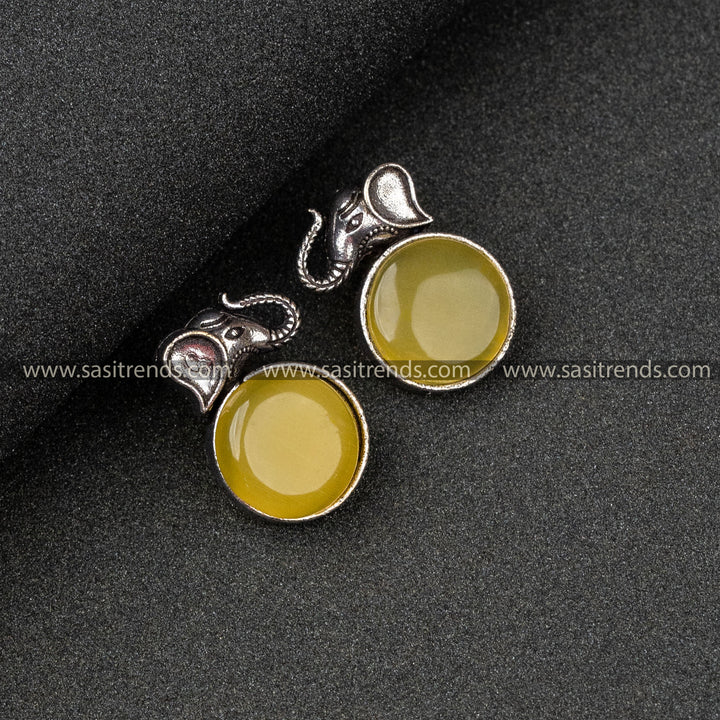 Trendy Oxidised German Silver Elephant Head And Round Monalisa Stone Yellow Earrings