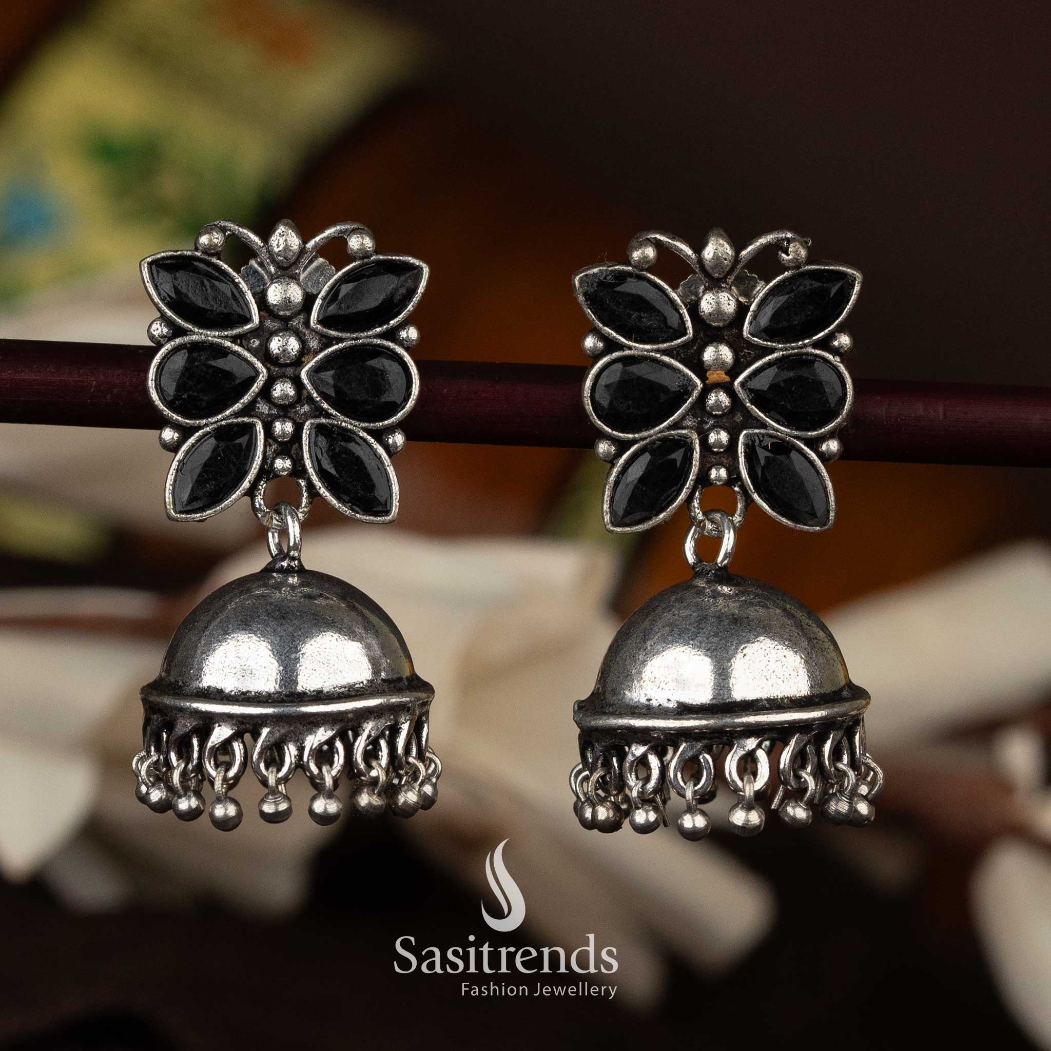 Black oxidised jhumka earrings with detailed floral design and dangling beads - Sasitrends