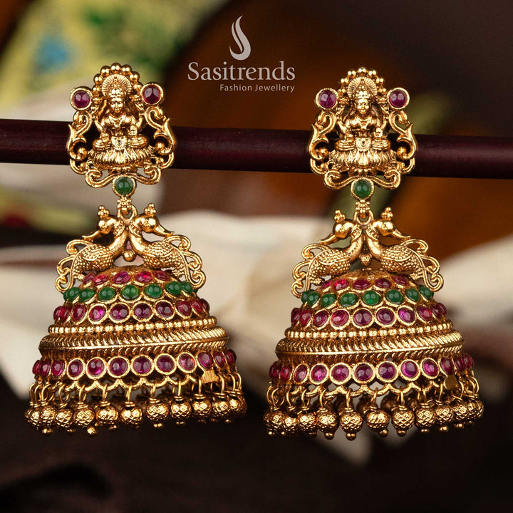 Temple bridal Lakshmi jhumka earrings in ruby green with matte gold finish - Sasitrends