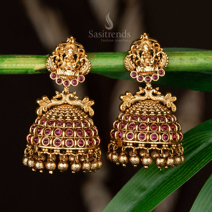 Ruby bridal jhumkas with hanging golden beads and peacock designs in matte gold - Sasitrends