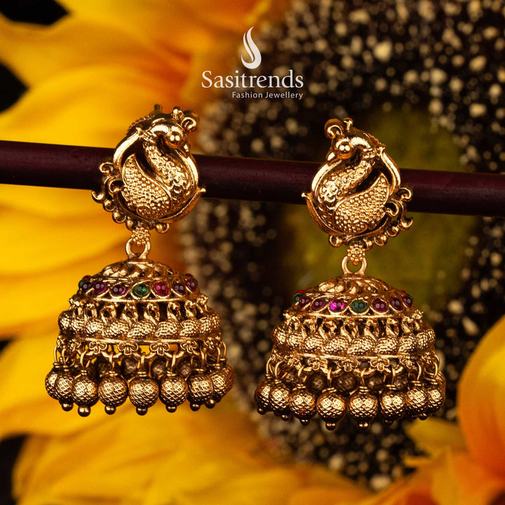 Traditional Peacock Motif Temple Matte Gold Jhumka Earrings with Ruby and Green Stones - Sasitrends