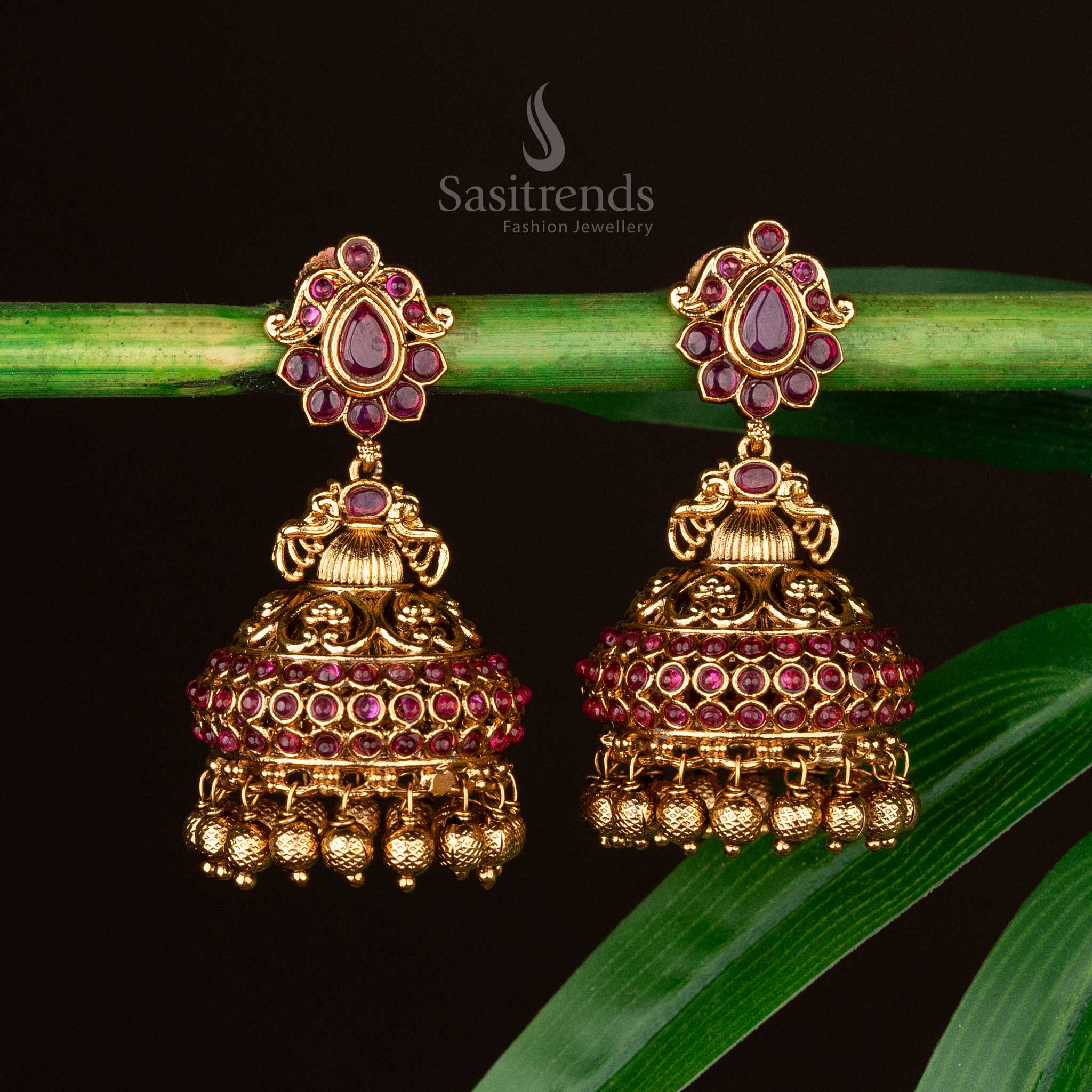 Ruby bridal jhumkas featuring intricate temple design and golden beads - Sasitrends