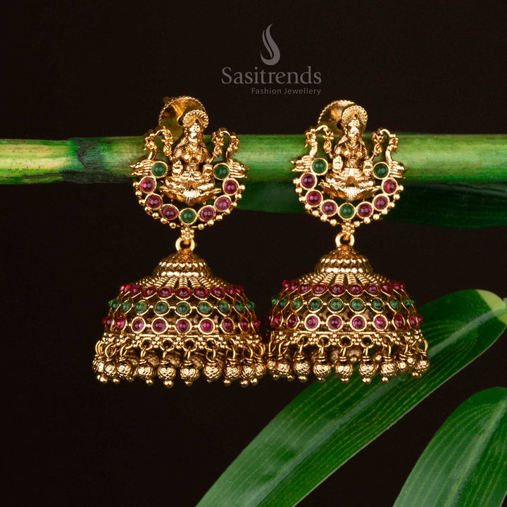 Dual-tone temple earrings with Lakshmi motif, ruby-green dome, and golden beads - Sasitrends