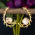 Nature-inspired gold antler earrings cradling a Mother of Pearl stone