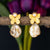 Delicate butterfly motif gold earrings with a preadolescent Mother of Pearl drop