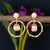Elegant golden hoops with dangling Mother of Pearl charm for a chic look
