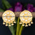 Floral golden disc earrings with pearl details and tassel charm, perfect for a touch of elegance