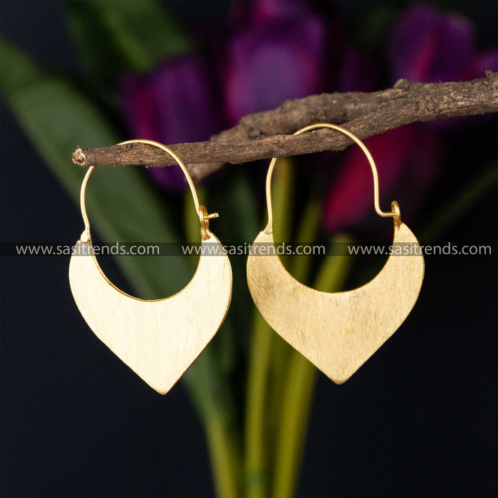 Gold-plated curved hoop earrings with a smooth finish against a dark background