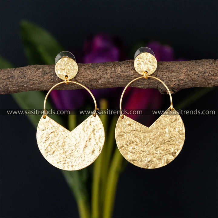 Textured gold half-moon dangle earrings with circular hooks on a twig