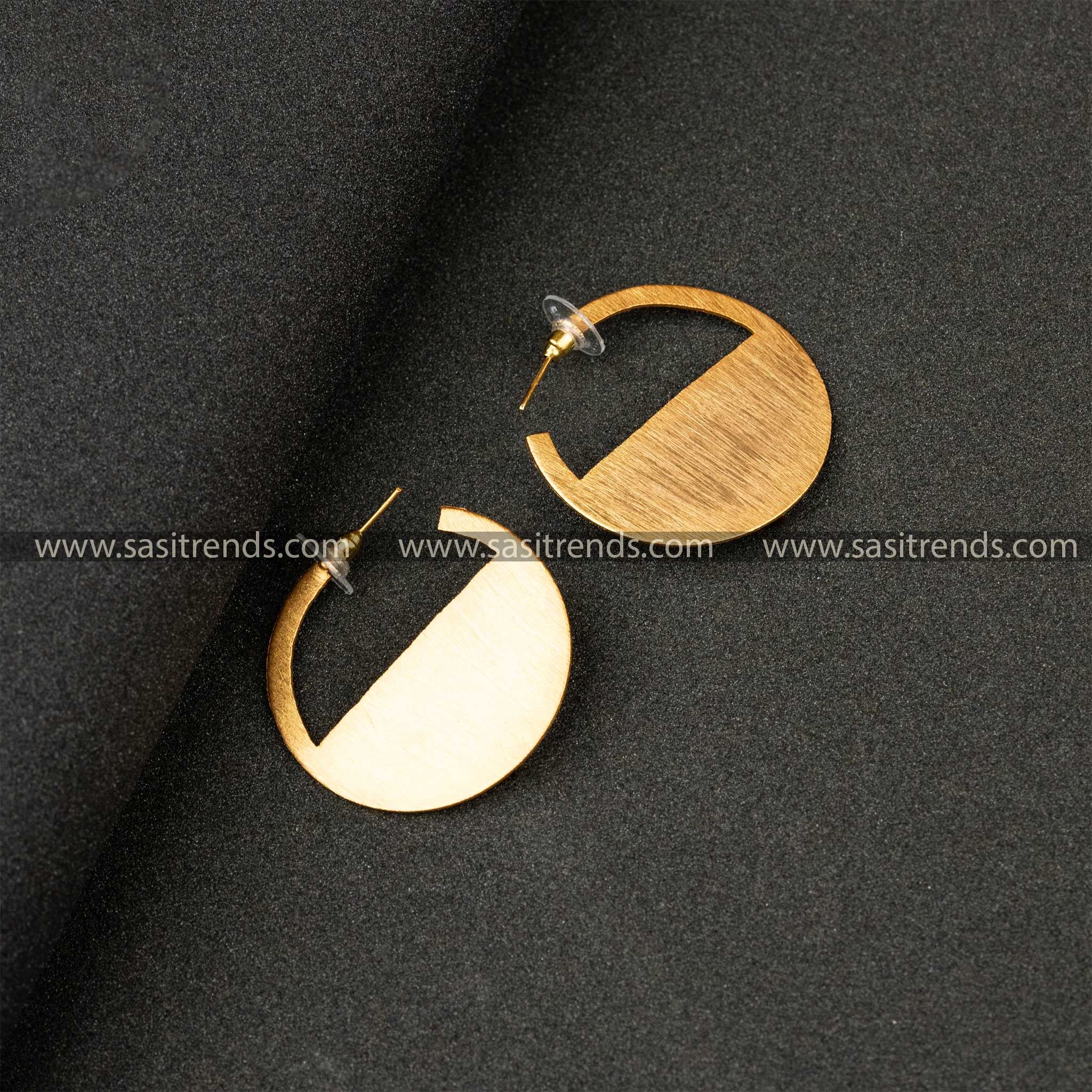 Sleek gold-plated semicircle stud earrings with a satin finish on a black surface