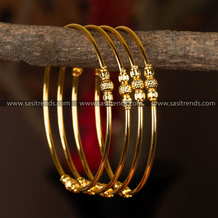 Set of four micro gold-plated kada bangles with ornate golden bead detailing