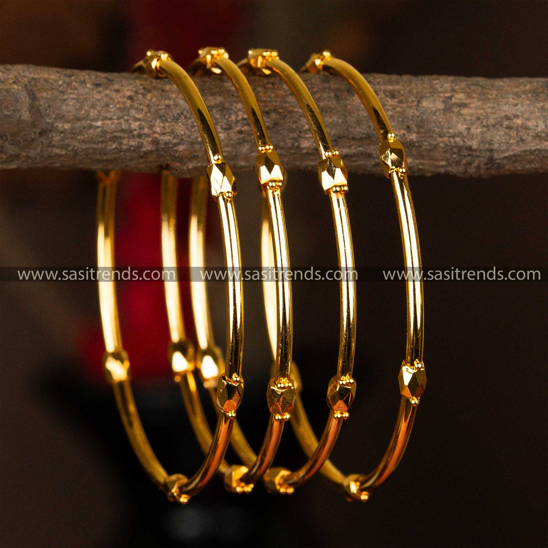 Set of four micro gold-plated kada bangles with elegant faceted golden beads