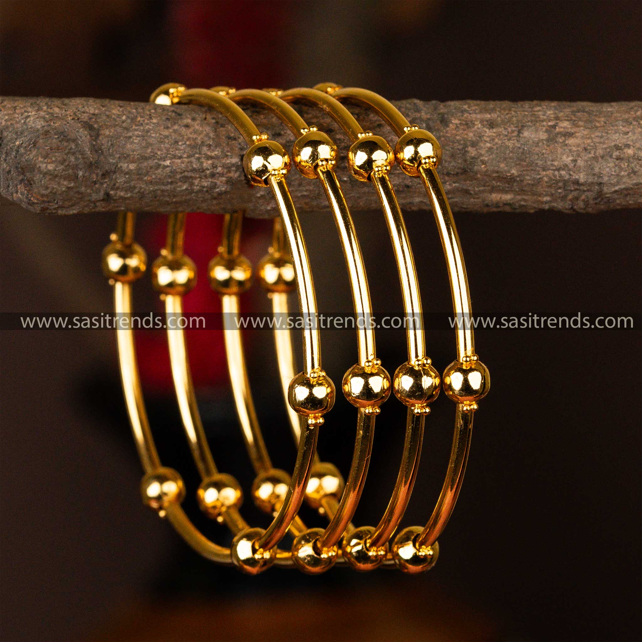 Set of four micro gold-plated kada bangles embellished with symmetrical golden orbs