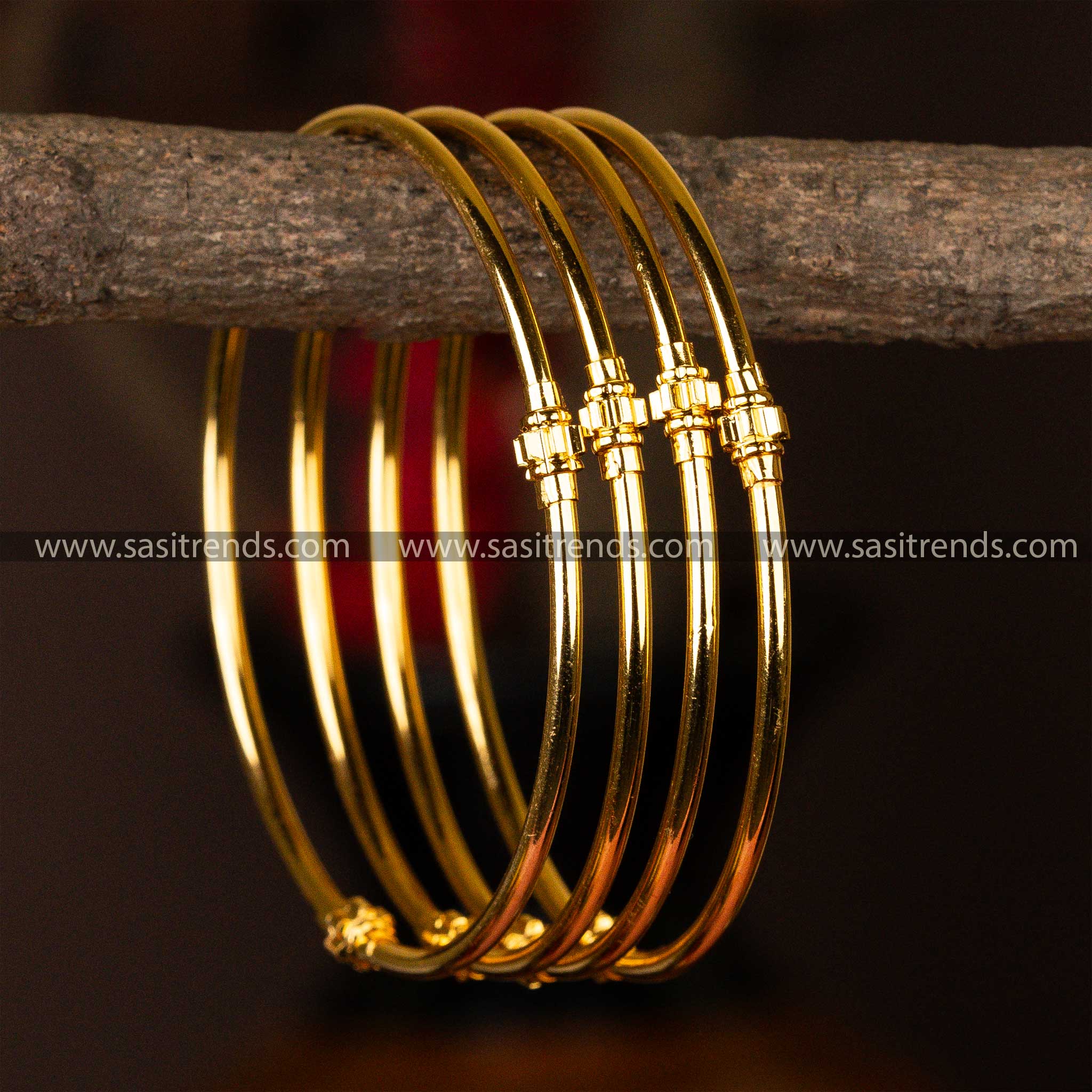 Set of four elegantly micro gold-plated kada bangles with symmetric golden bead accents