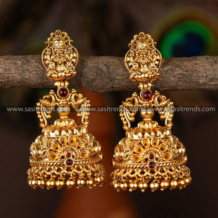 Traditional bridal temple jhumka earrings adorned with gold-plated peacocks and precious emerald and ruby stones