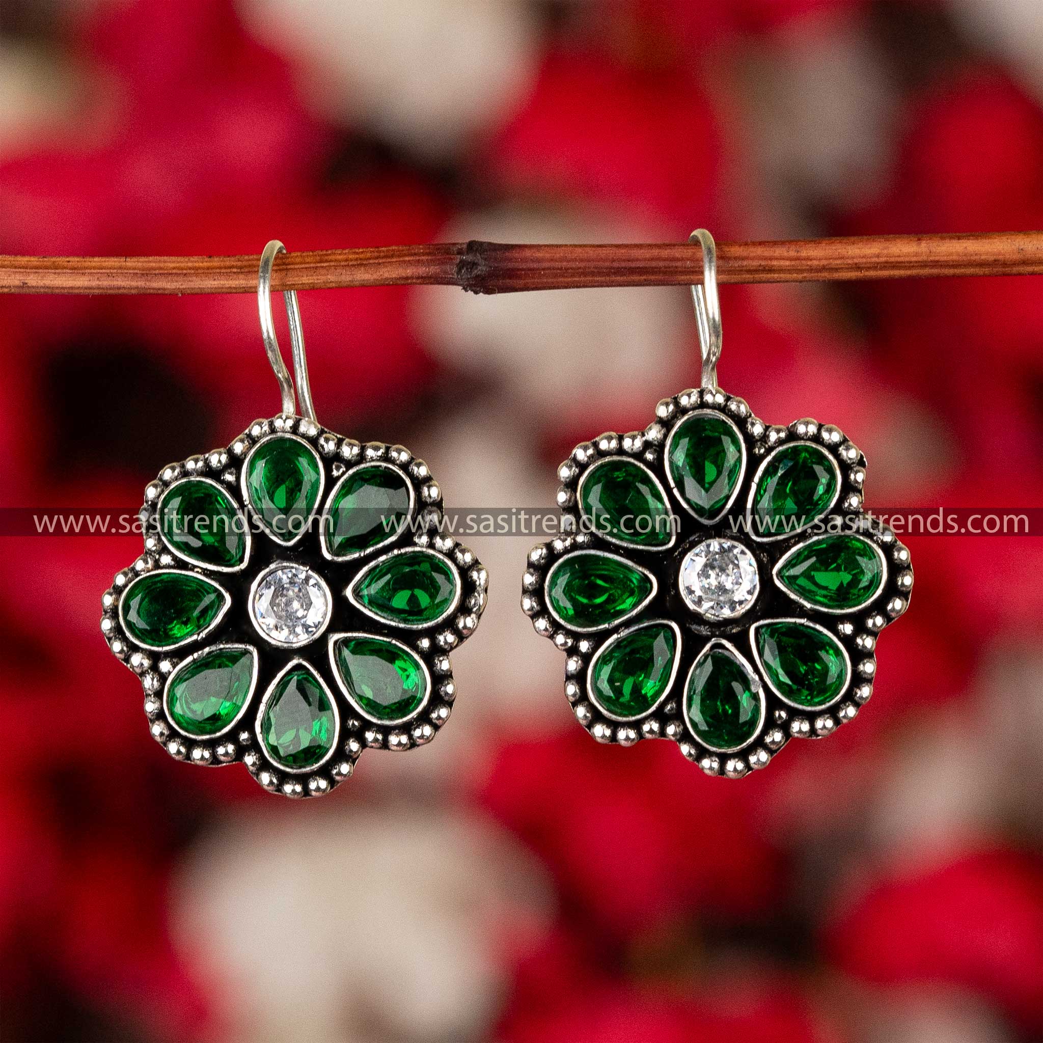 Emerald green stone-studded oxidized silver floral earrings