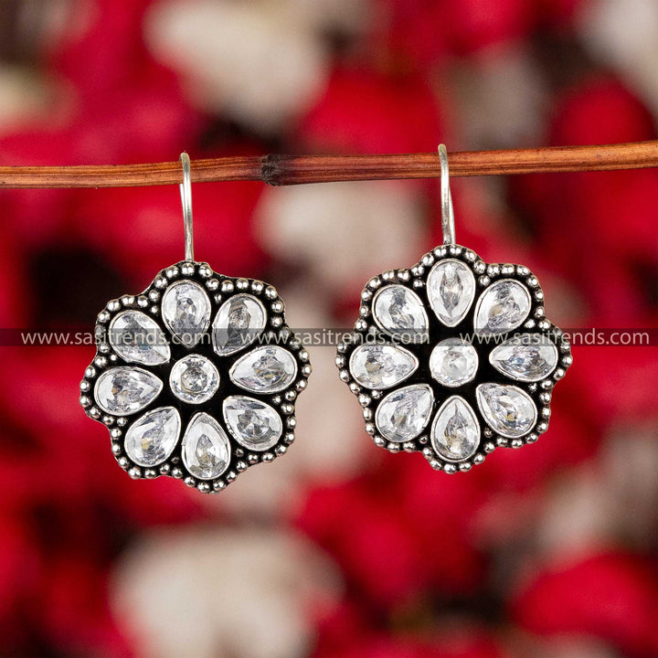 Sapphire blue stone-studded oxidized silver floral earrings