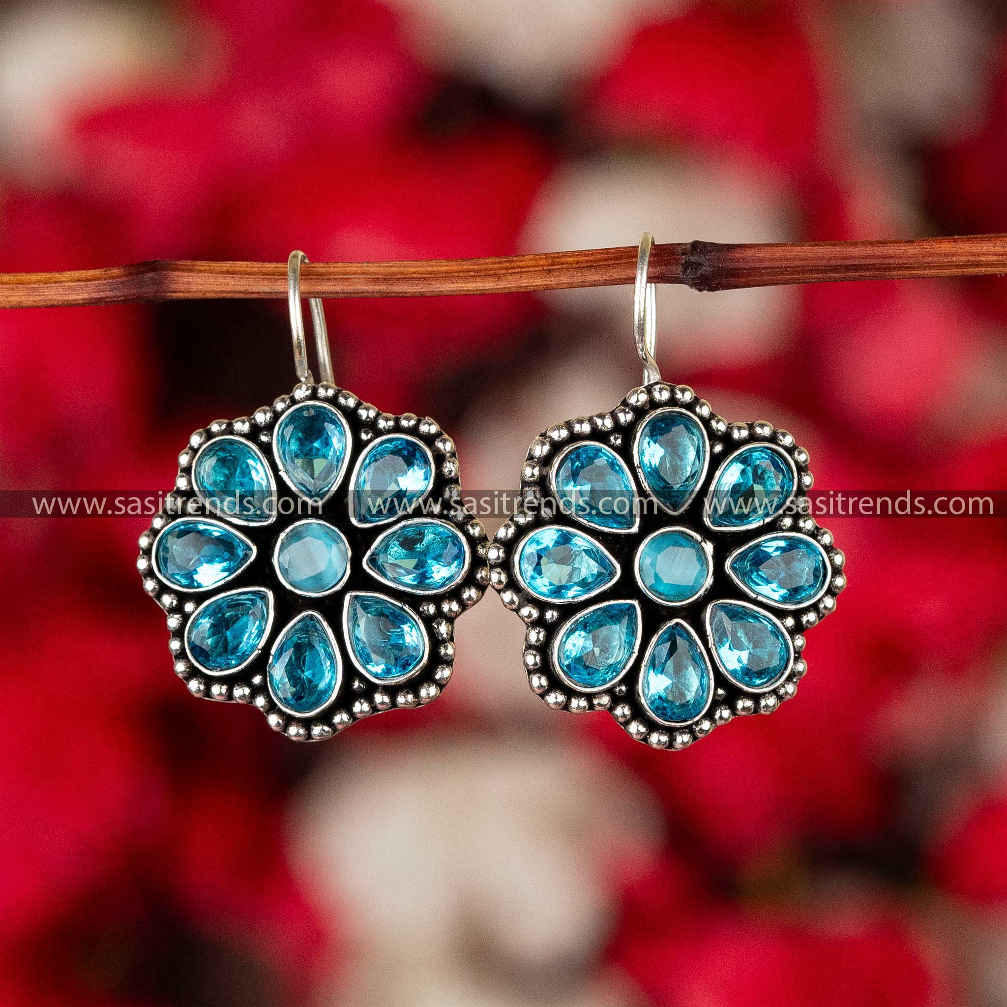 Teal stone-studded oxidized silver floral earrings