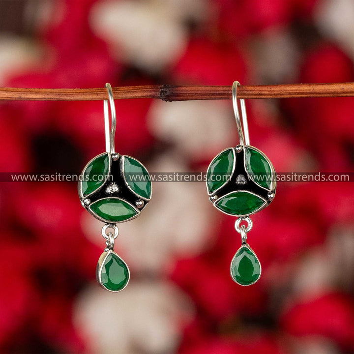 Emerald green stone earrings in oxidised German silver with floral accents