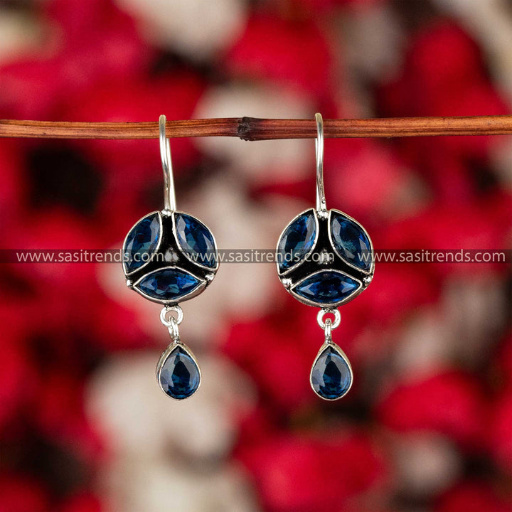 Sapphire blue stone-studded oxidised German silver earrings with a floral pattern