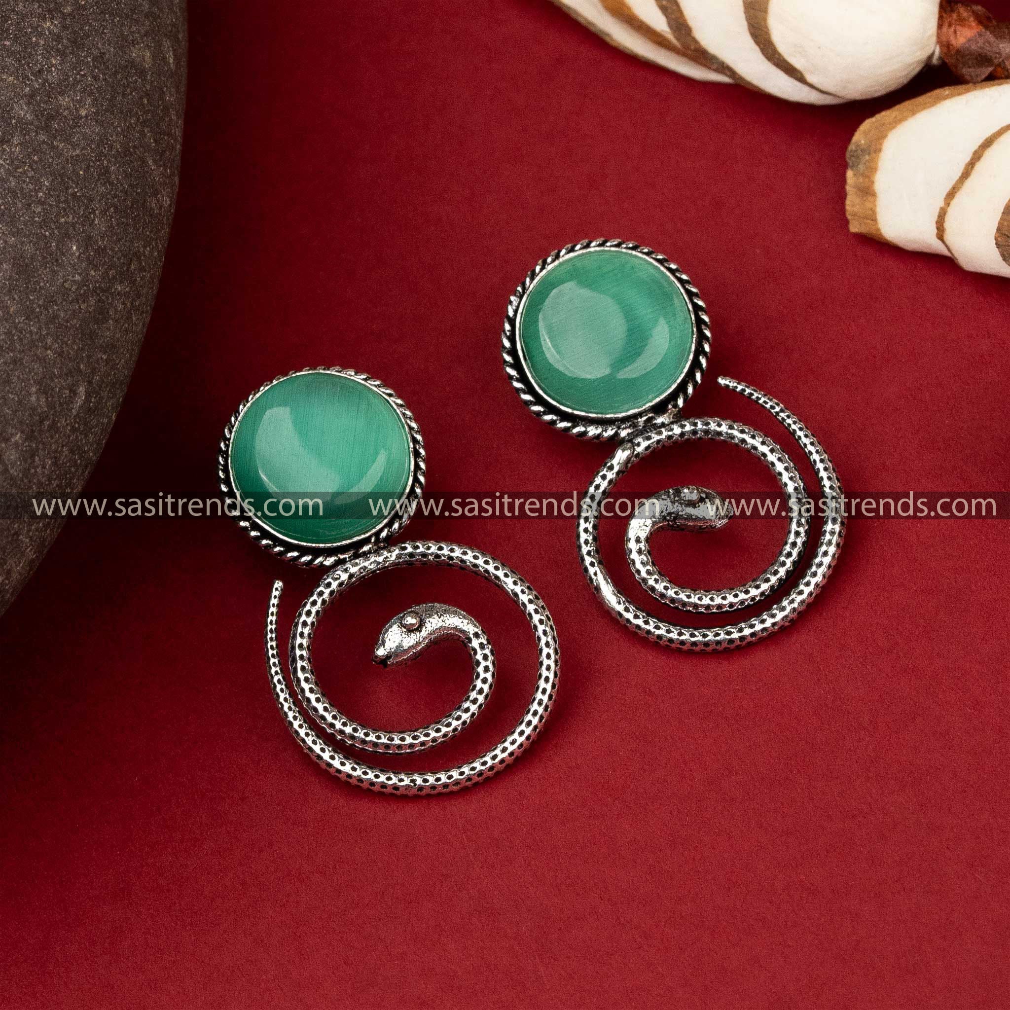 Coiled snake earrings featuring emerald Mint Monalisa stone