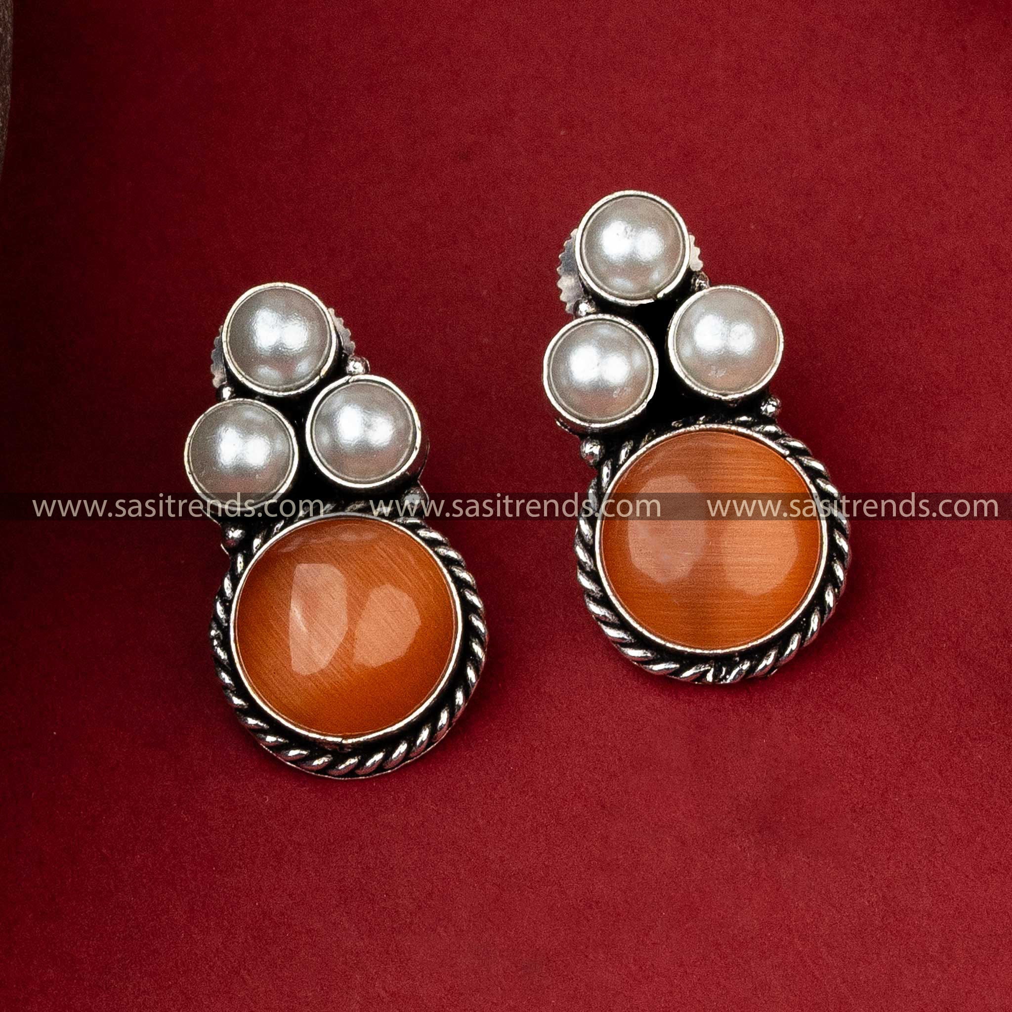 Oxidised silver earrings with a triangular pearl pattern and a warm peach Monalisa stone for a subtle charm.