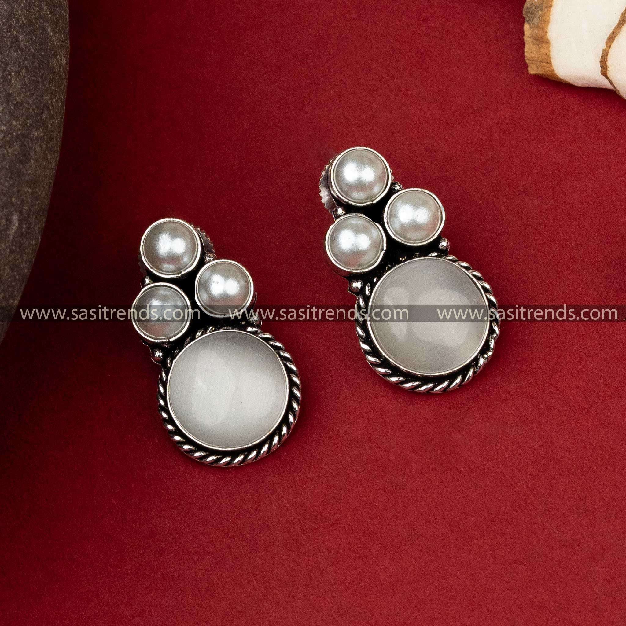 Elegant oxidized silver earrings with a triad of lustrous pearls set above a round grey Monalisa stone