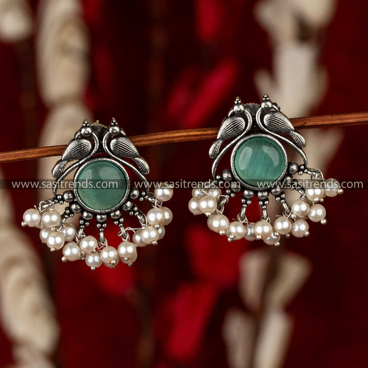 Mint Monalis stone set in ornate oxidised peacock earrings with pearl details