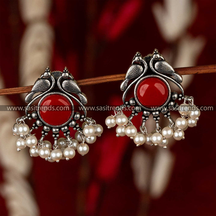 Oxidised peacock earrings with a radiant crimson stone and a fringe of pearls