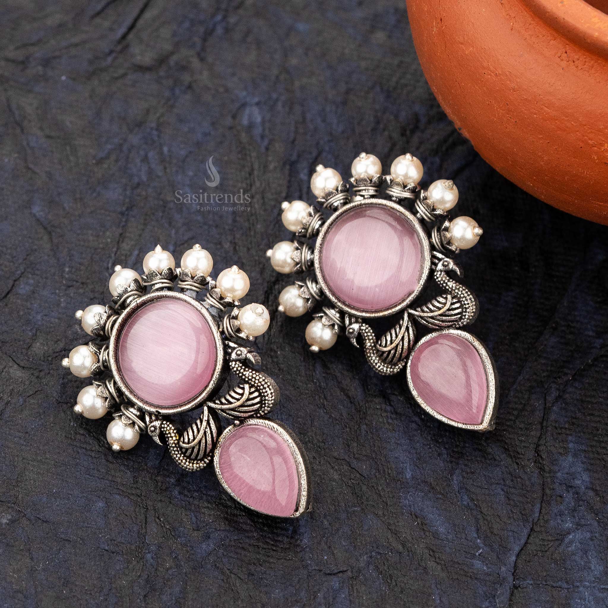 Pink office wear earrings featuring peacock wings and clustered pearls - sasitrends