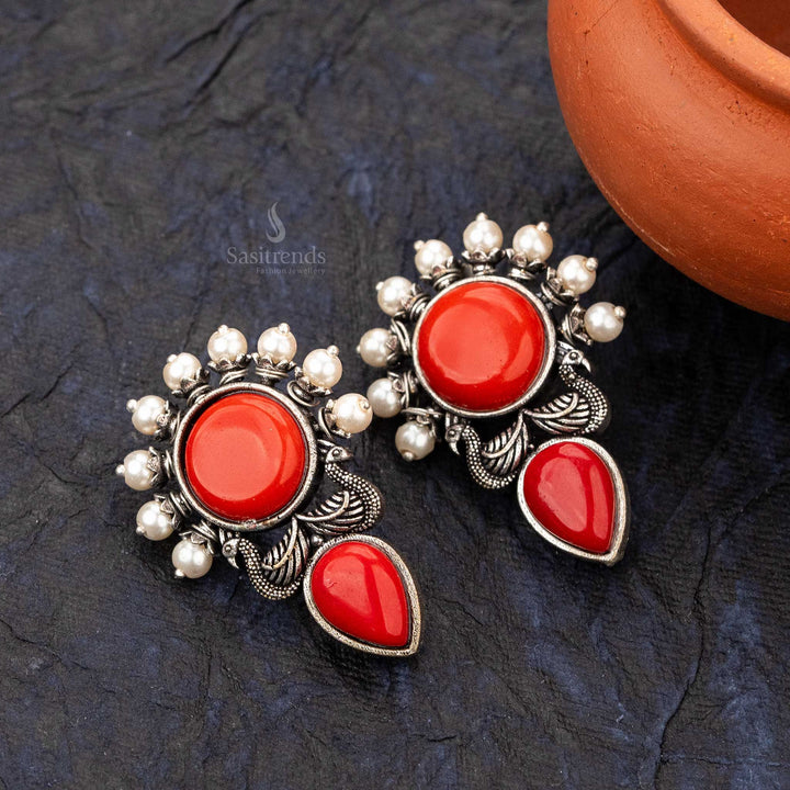 Red stone office wear earrings with intricate peacock and crescent pearl accents - sasitrends