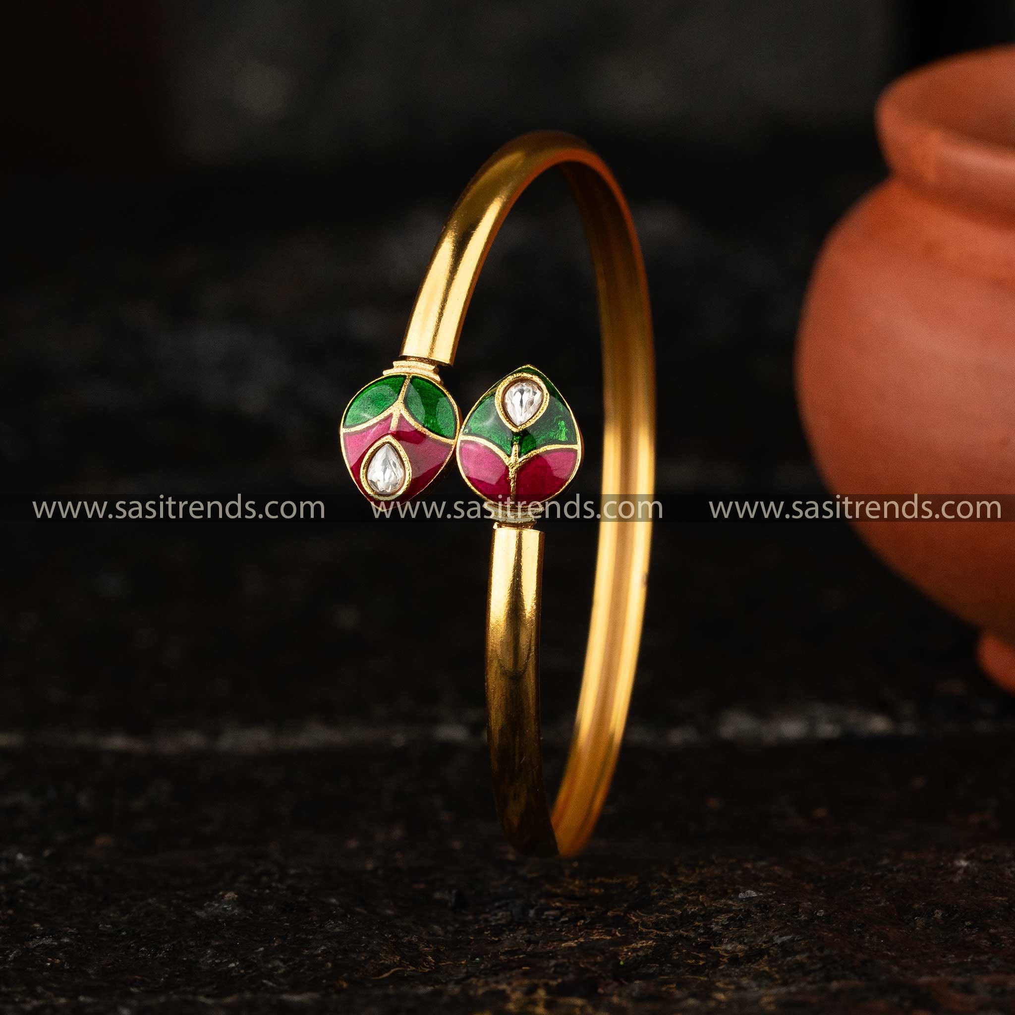 Matte Gold Kada Bangle with vibrant green and red enamel detailing in a traditional Kundan setting.