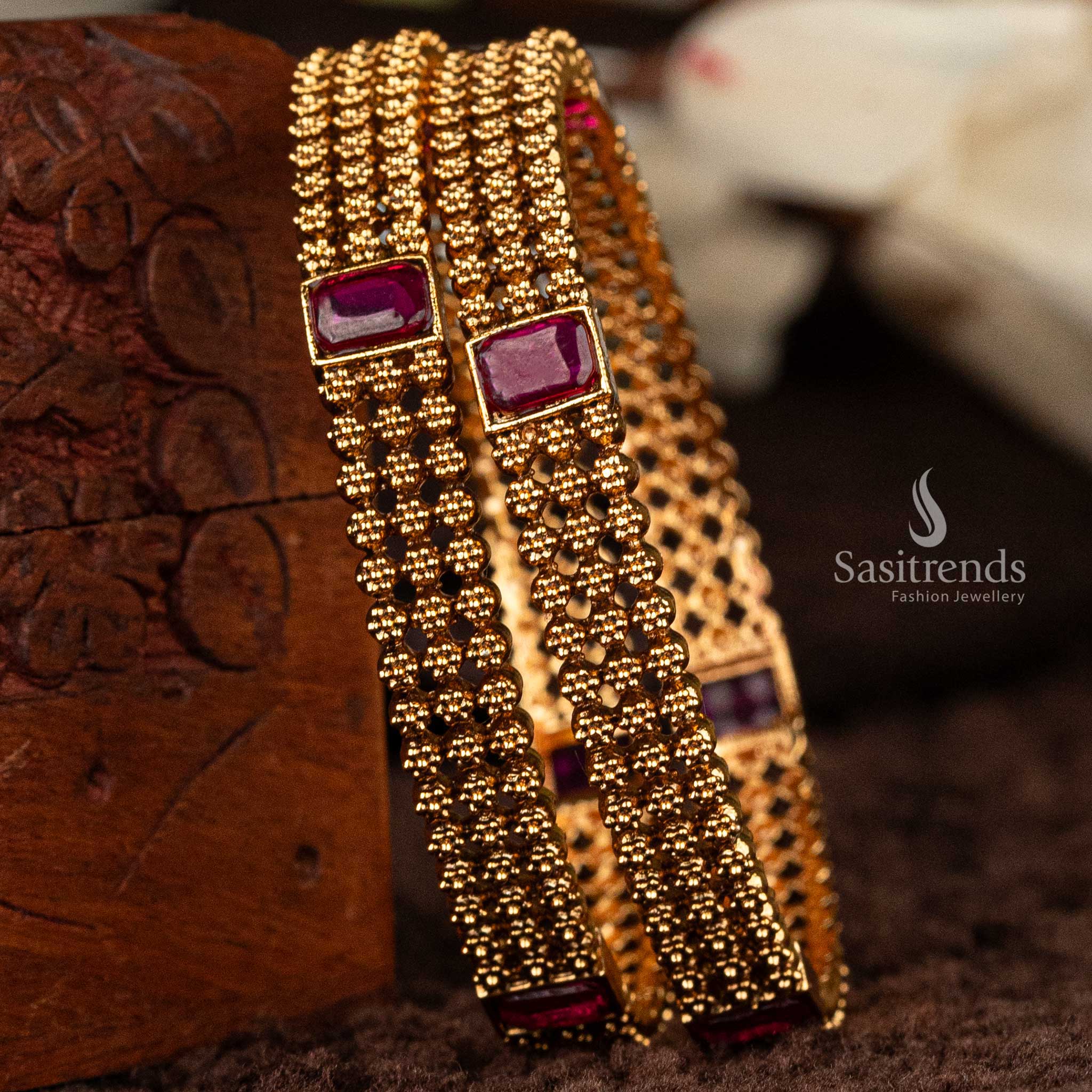 Matte gold-plated bangles with traditional ruby-stone detailing - Sasitrends